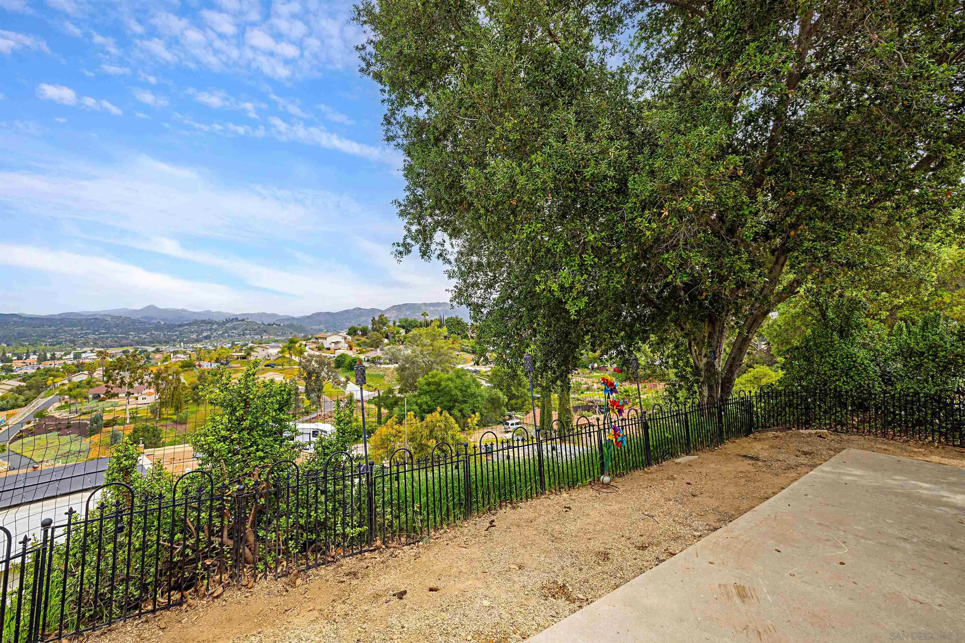 9100 Single Oak Drive, Unit 24 Lakeside, CA 92040 - Photo 25 of 48 a view of a pathway both side of residential houses with city view