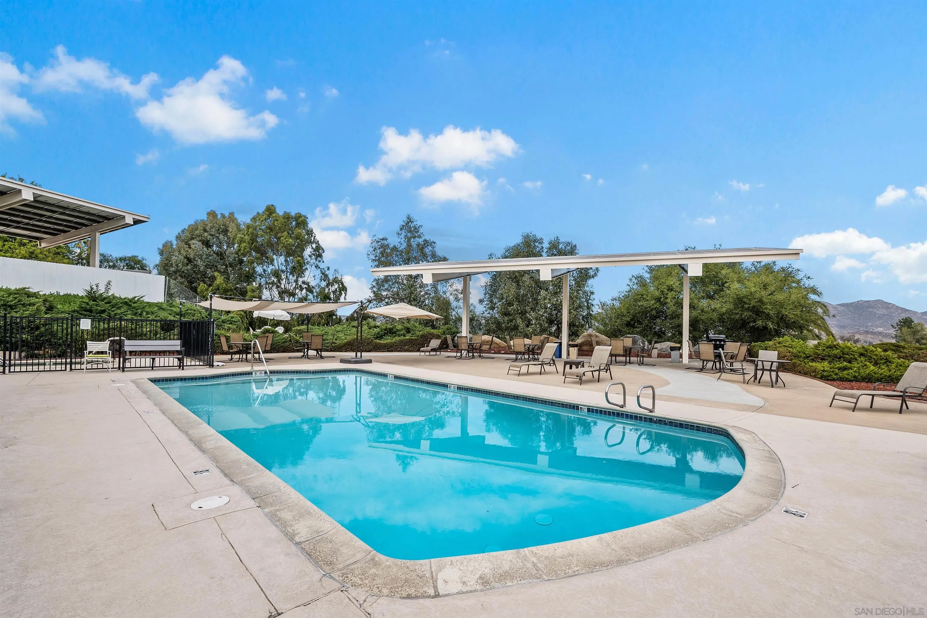 9100 Single Oak Drive, Unit 24 Lakeside, CA 92040 - Photo 37 of 48 a view of a swimming pool with outdoor seating