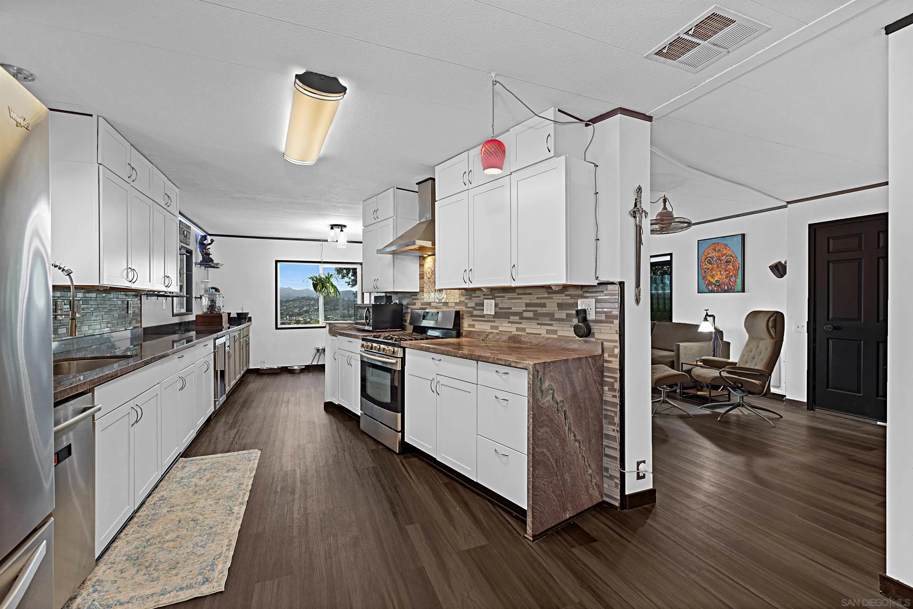 9100 Single Oak Drive, Unit 24 Lakeside, CA 92040 - Photo 4 of 48 a kitchen with white cabinets and appliances