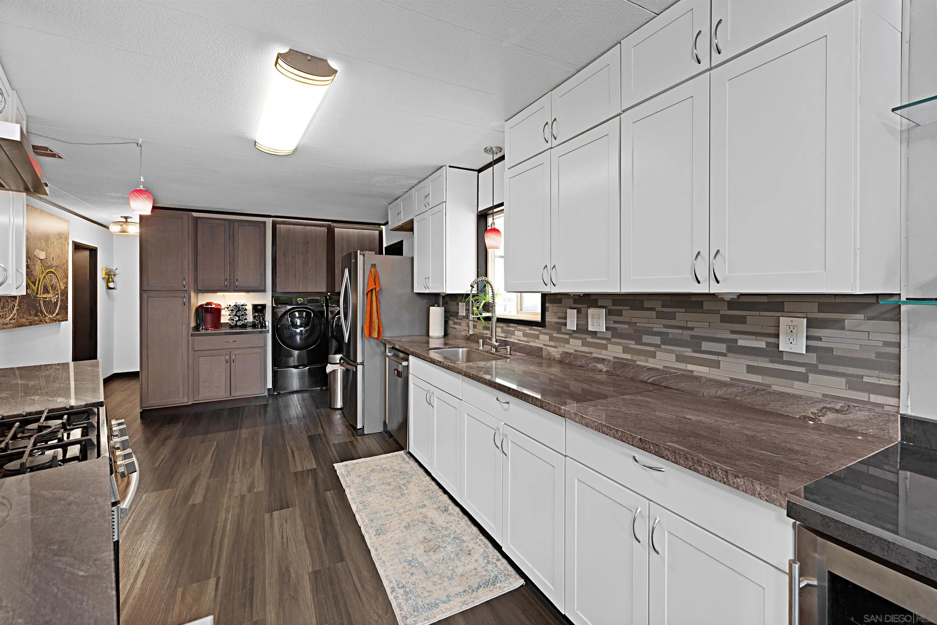 9100 Single Oak Drive, Unit 24 Lakeside, CA 92040 - Photo 8 of 48 a kitchen with stainless steel appliances granite countertop a refrigerator a stove and a sink