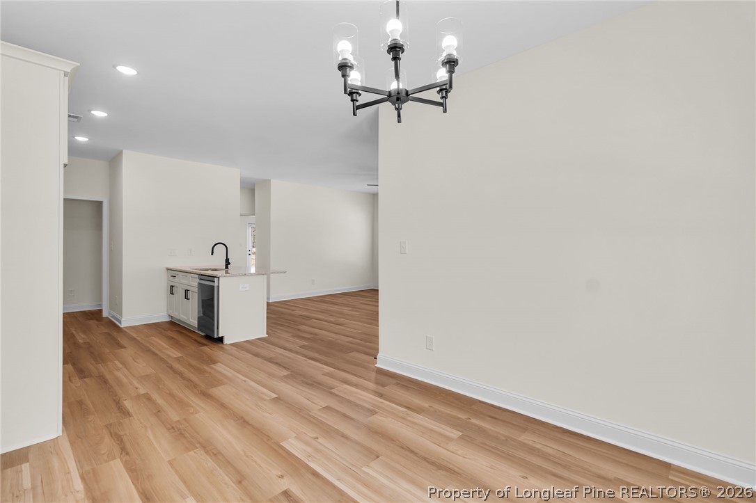 131 Merle Road Pinebluff, NC 28373 - Photo 15 of 33 a view of a kitchen with a refrigerator and a ceiling fan