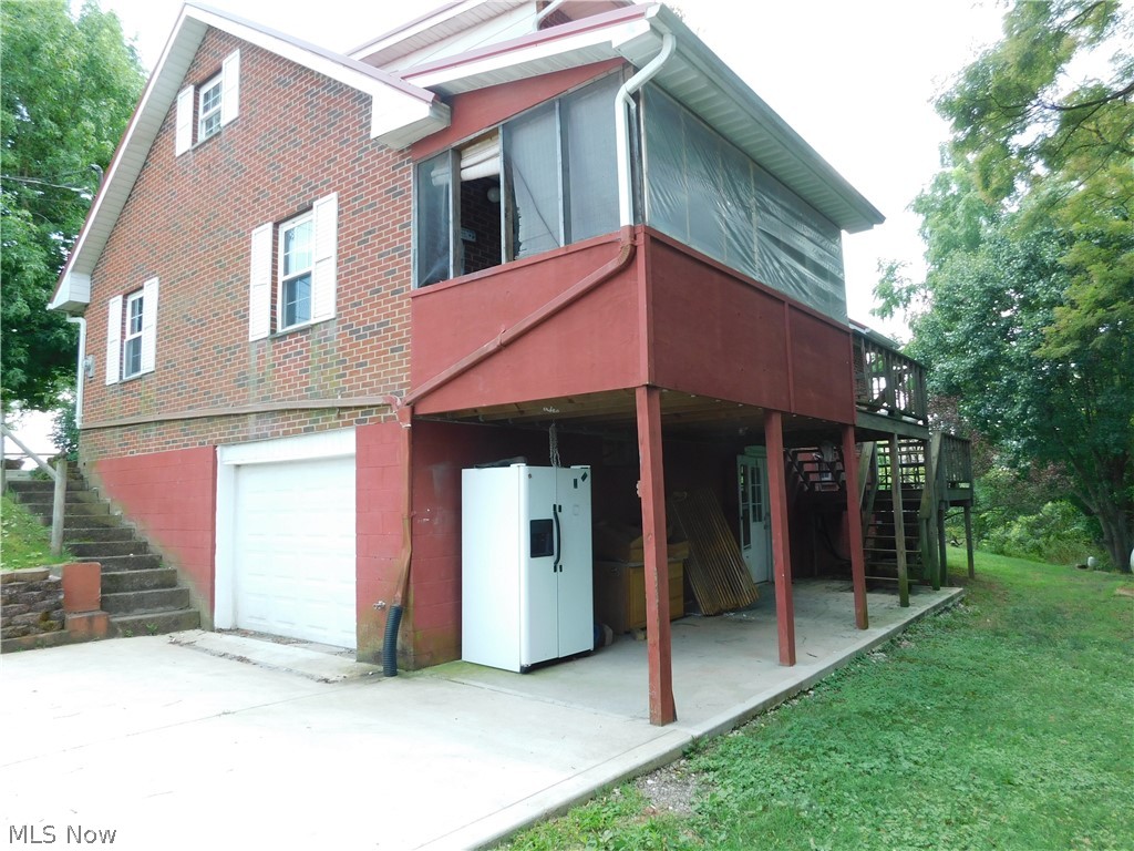 31 Pine Run Road Washington, WV 26181 - Photo 24 of 25 View of the back of the home. Owner working on screened in porch area to dress it up nicely.