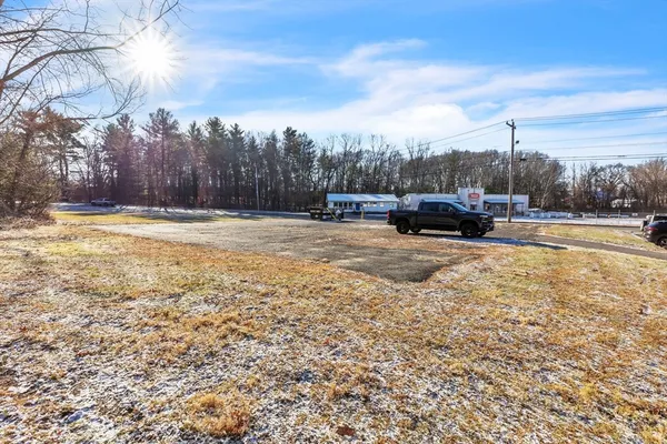a view of a yard with wooden fence