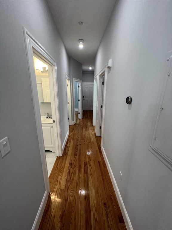 29 Alpine Street, Unit 1 Somerville, MA 02144 - Photo 12 of 33 a view of a hallway with wooden floor and staircase