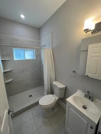 a bathroom with a toilet sink and shower