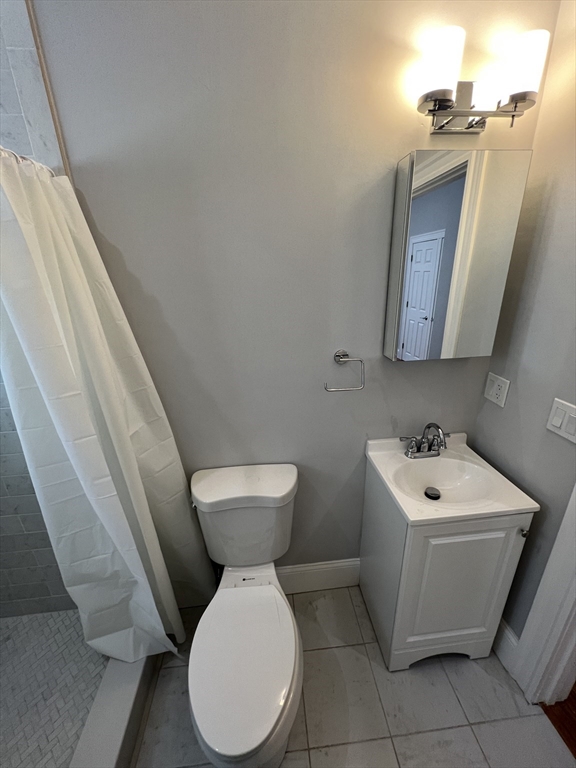 29 Alpine Street, Unit 1 Somerville, MA 02144 - Photo 15 of 33 a white toilet sitting next to a white sink