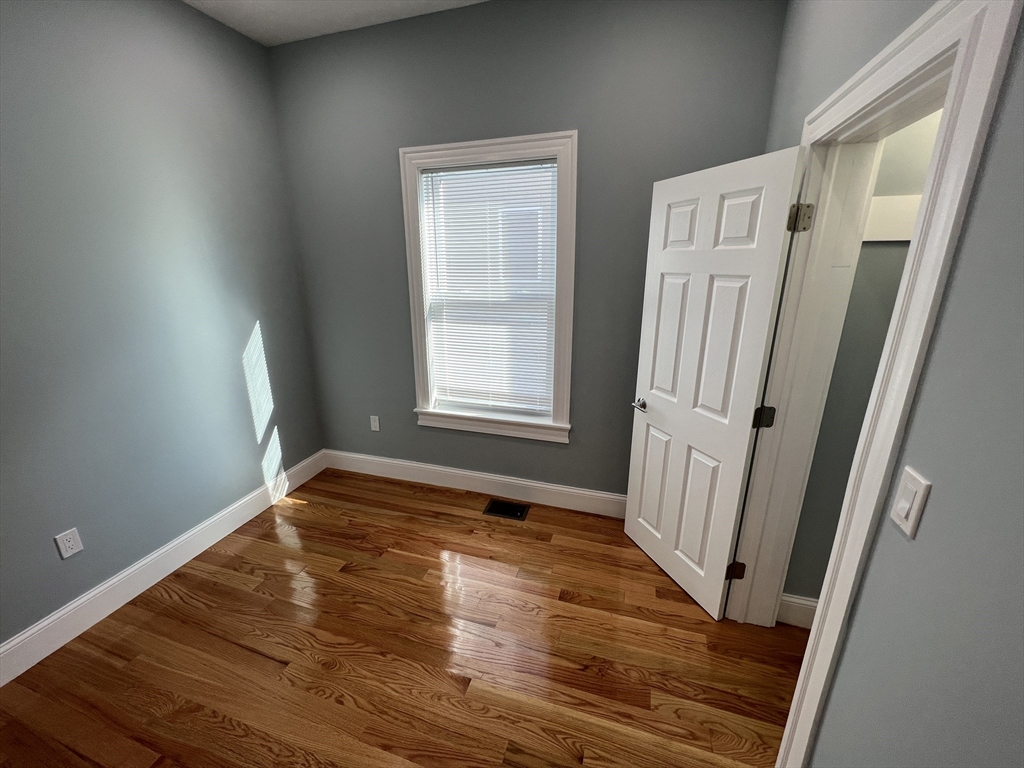 29 Alpine Street, Unit 1 Somerville, MA 02144 - Photo 31 of 33 a view of an empty room with wooden floor and a window