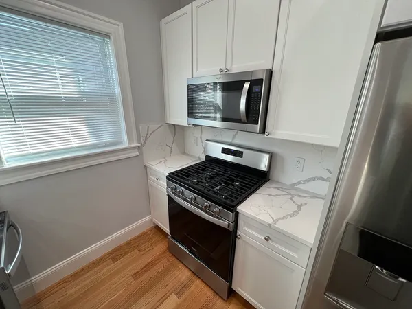 a kitchen with a stove microwave and sink