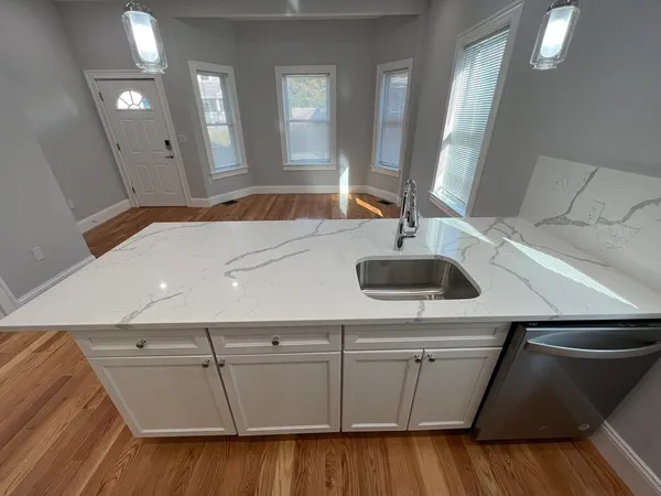a kitchen with a sink and a mirror
