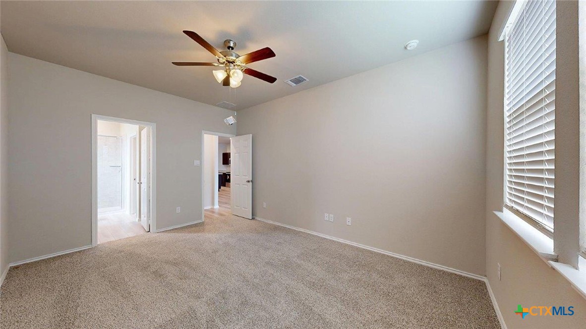 1111 Stone Vly Road Temple, TX 76502 - Photo 10 of 21 a view of an empty room with a ceiling fan and window