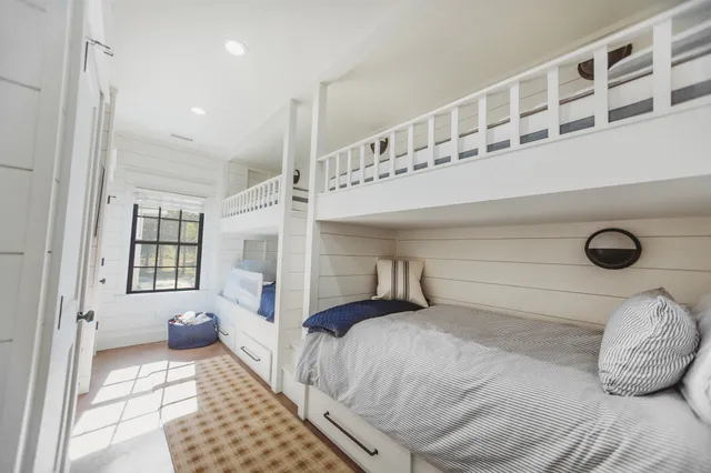 a bedroom with a bed and a book shelf