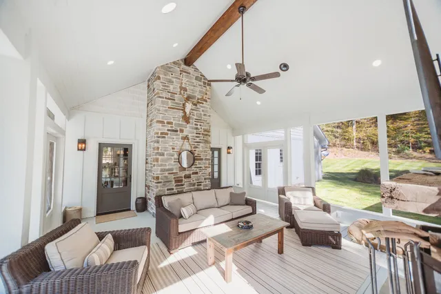 a view of a patio with table and chairs potted plants and large tree