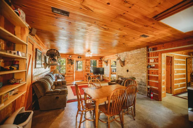 a living room with patio furniture and a fireplace