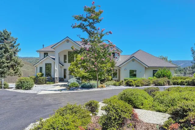 a view of a big room with wooden floor and a chandelier