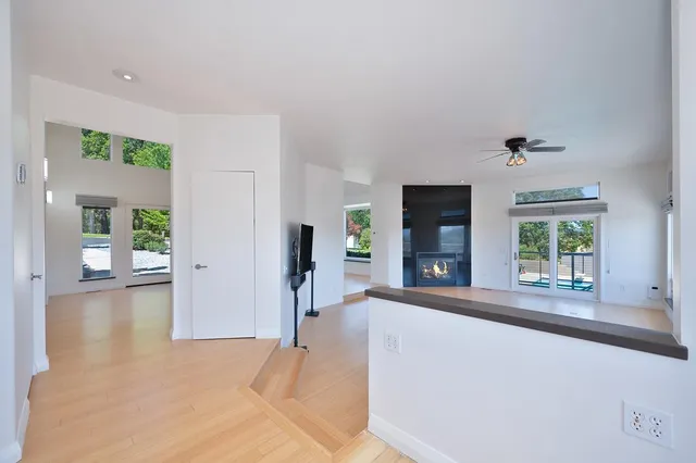 a kitchen with wooden floors and white cabinets