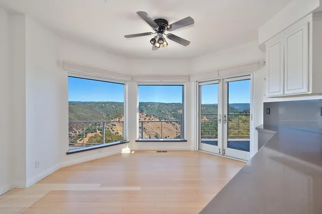 a view of balcony with wooden floor and lake view