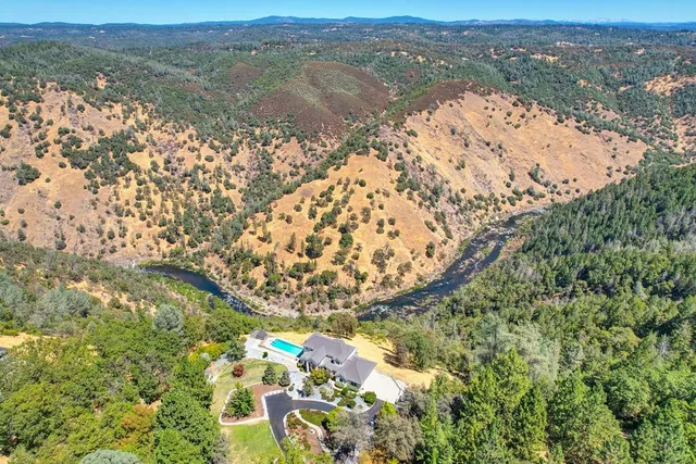 a view of a hallway with wooden floor and a cabinet