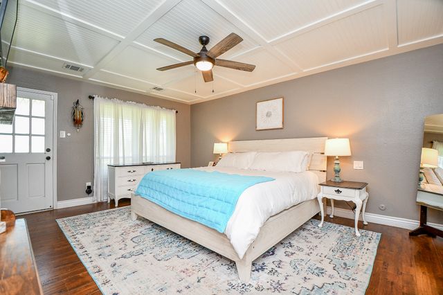 a bedroom with a large bed and a rug