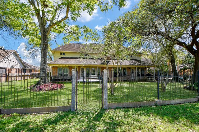 a front view of a house with a yard table and chairs
