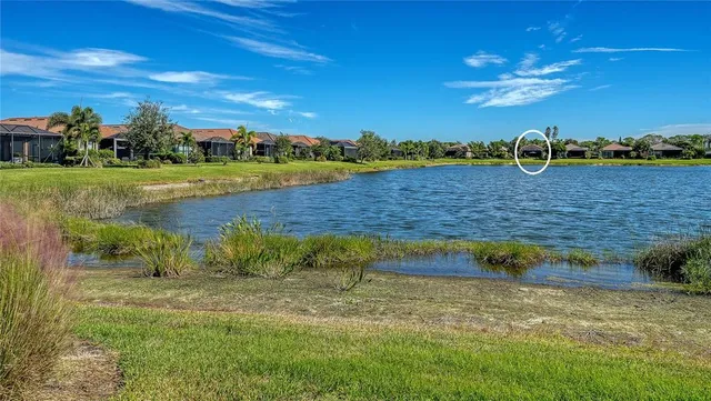 a view of a patio with couple of chairs and a fire pit