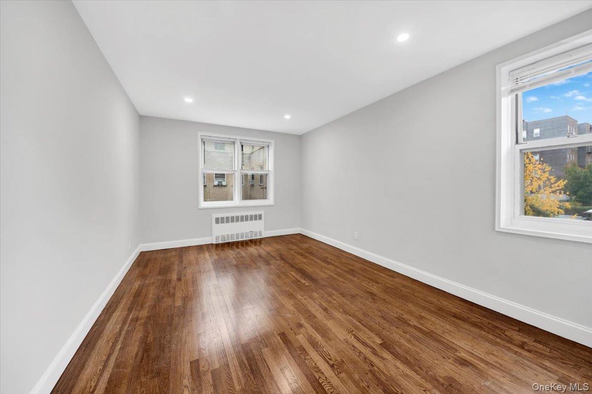 4265 Webster Avenue, Unit 5C Bronx, NY 10470 - Photo 11 of 21 an empty room with wooden floor and windows