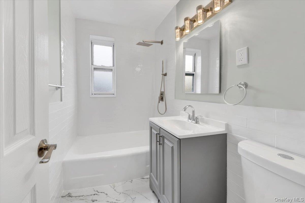 4265 Webster Avenue, Unit 5C Bronx, NY 10470 - Photo 14 of 21 a bathroom with a sink a toilet and shower