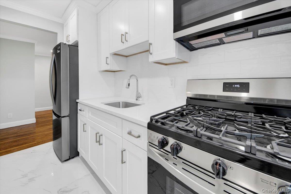 4265 Webster Avenue, Unit 5C Bronx, NY 10470 - Photo 4 of 21 a white stove top oven sitting inside of a kitchen