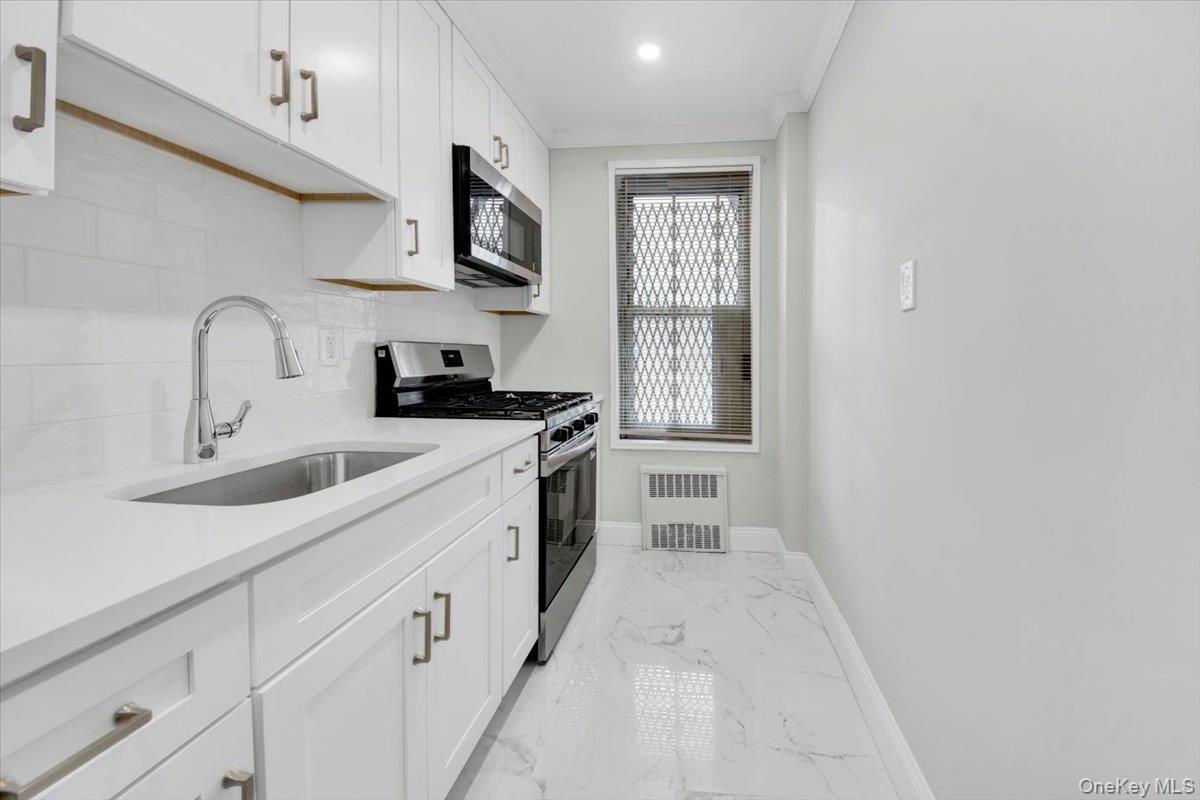 4265 Webster Avenue, Unit 5C Bronx, NY 10470 - Photo 6 of 21 a kitchen with white cabinets and sink