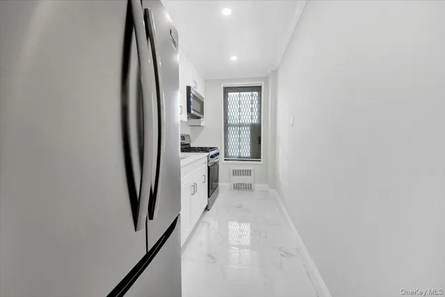 a hallway with white doors wooden floor and stair