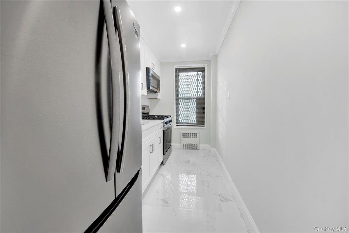 4265 Webster Avenue, Unit 5C Bronx, NY 10470 - Photo 7 of 21 a hallway with white doors wooden floor and stair