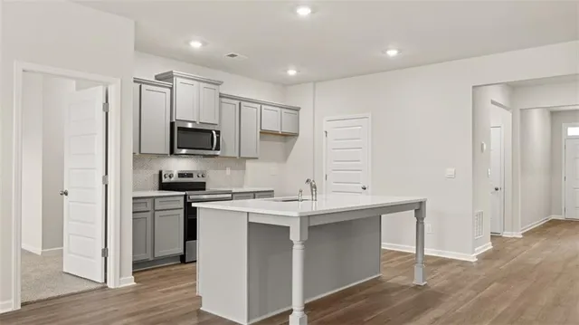 a kitchen with appliances cabinets and a sink
