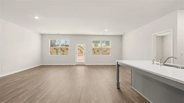 a view of a room with wooden floor and windows