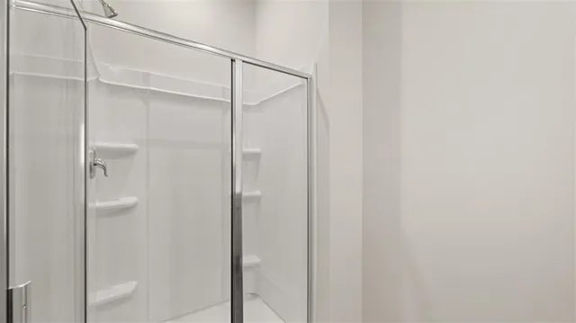 a bathroom with a glass shower door