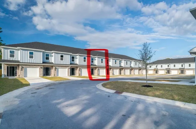 a view of pool with a big yard and large trees