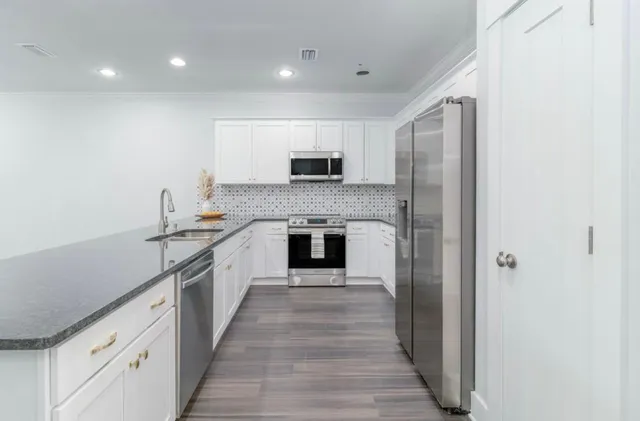 a large kitchen with a stove and a refrigerator