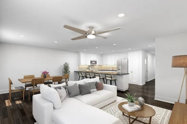a living room with furniture kitchen view and a dining table