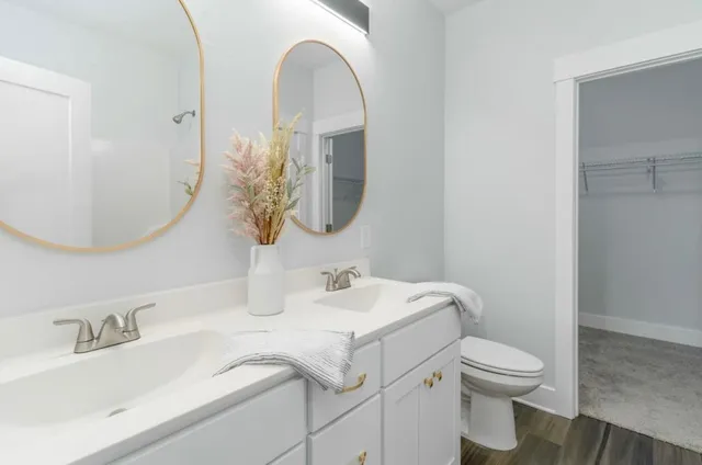 a bathroom with a toilet sink and mirror