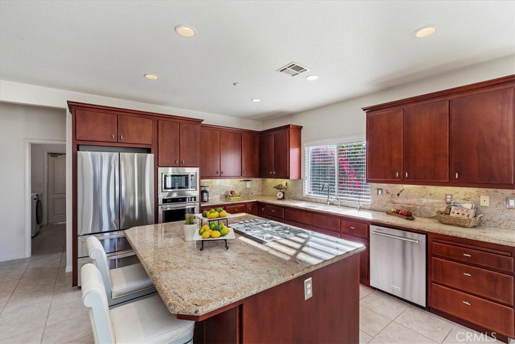 1260 Ransom Road Riverside, CA 92506 - Photo 16 of 50 a kitchen with a sink a counter top space and stainless steel appliances