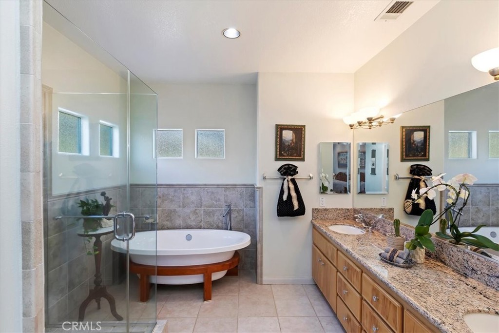 1260 Ransom Road Riverside, CA 92506 - Photo 23 of 50 a bathroom with a granite countertop sink a toilet and bathtub