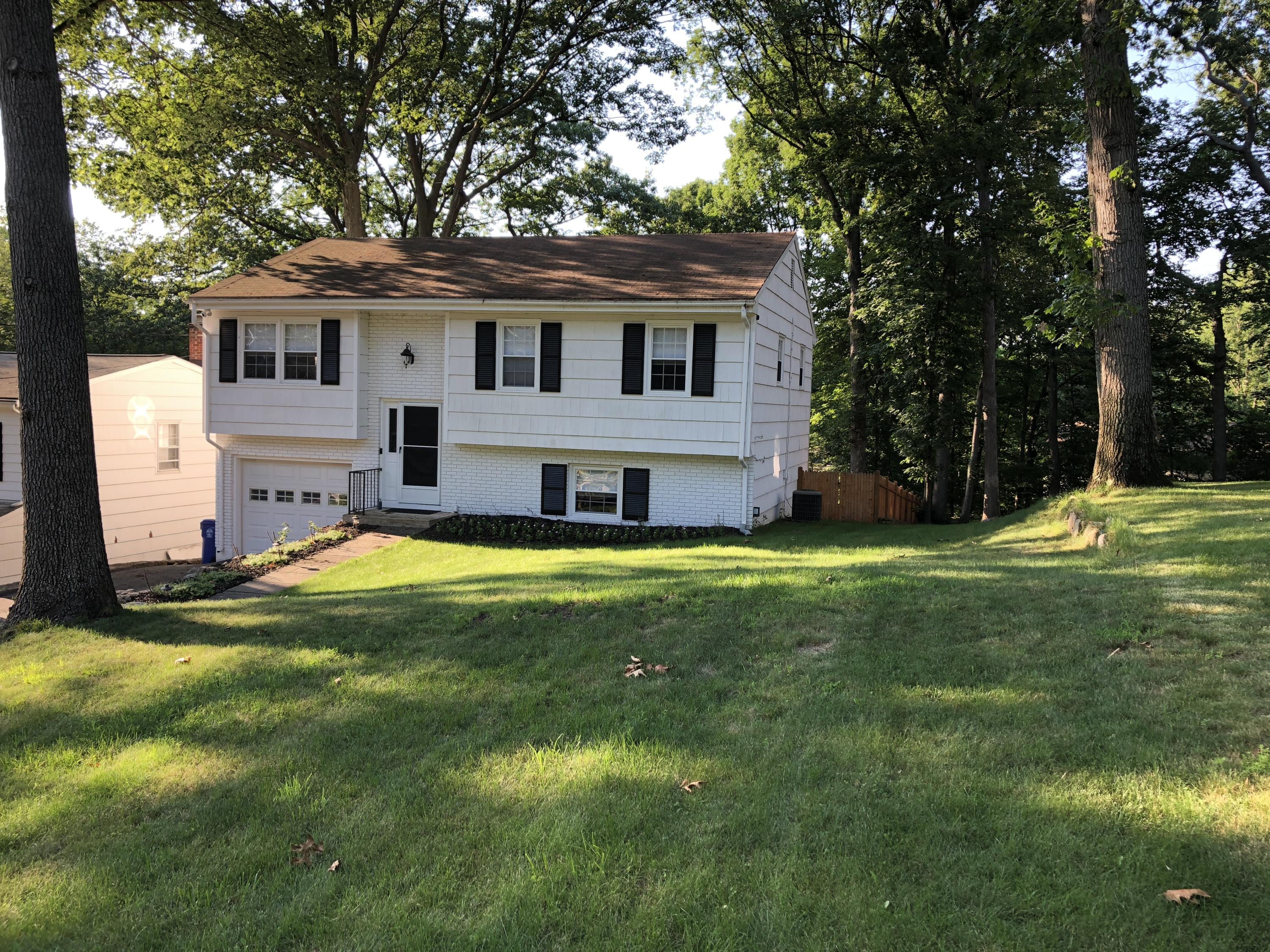 27 Thomes Street Rowayton, CT 06853 - Photo 1 of 19 a front view of a house with a yard