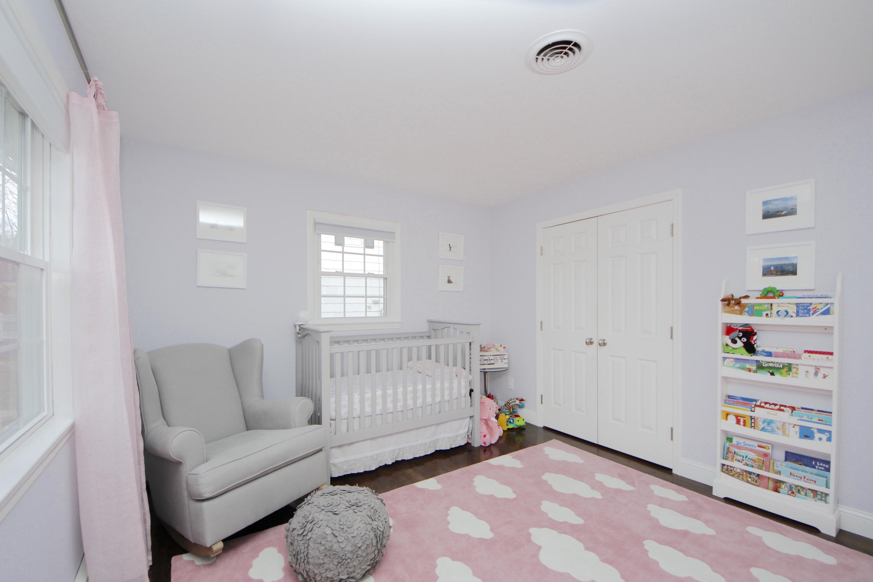 27 Thomes Street Rowayton, CT 06853 - Photo 13 of 19 a living room with furniture and a baby crib