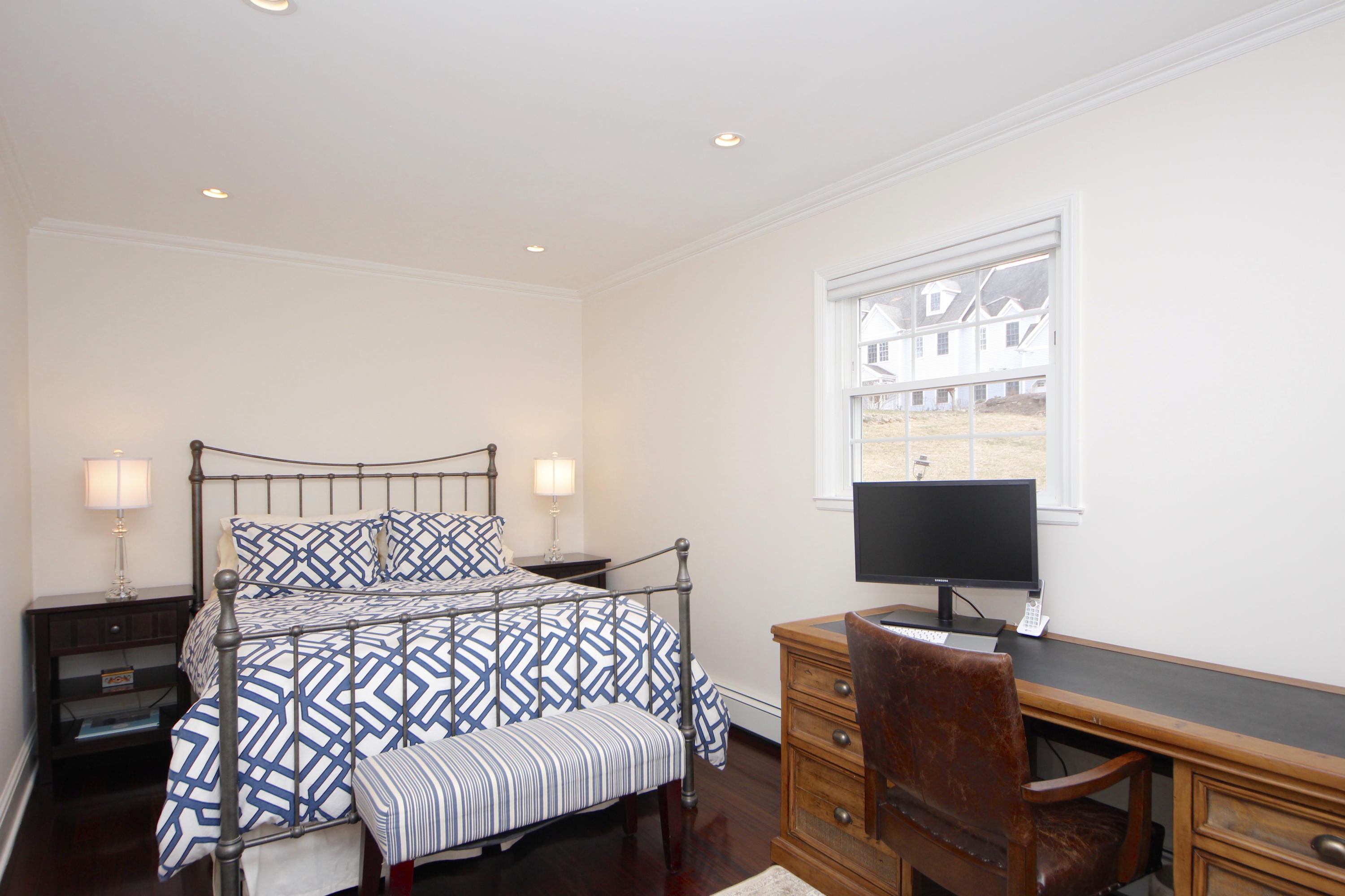 27 Thomes Street Rowayton, CT 06853 - Photo 14 of 19 a bedroom with a bed and a flat screen tv