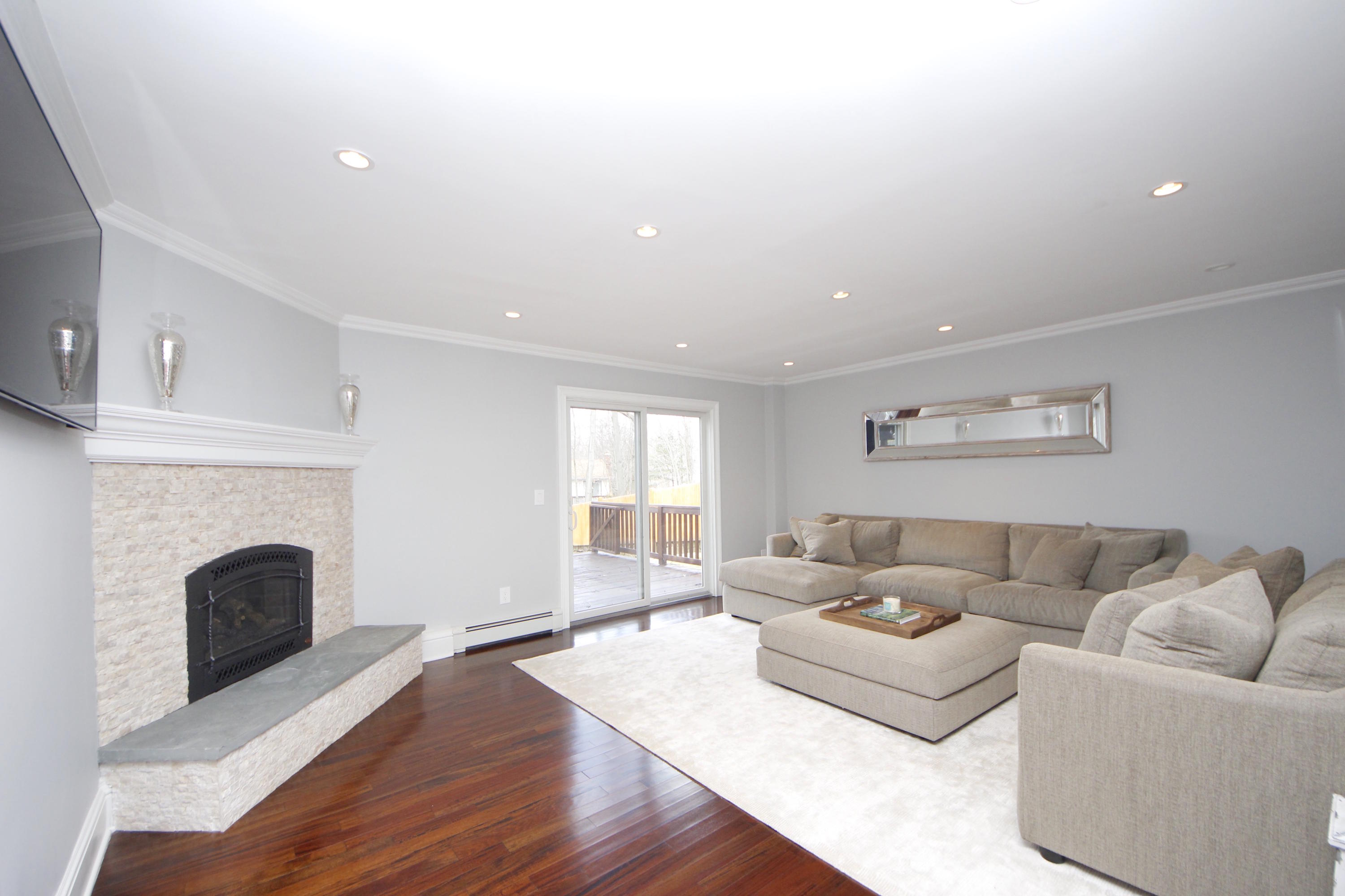 27 Thomes Street Rowayton, CT 06853 - Photo 3 of 19 a living room with furniture and a fireplace