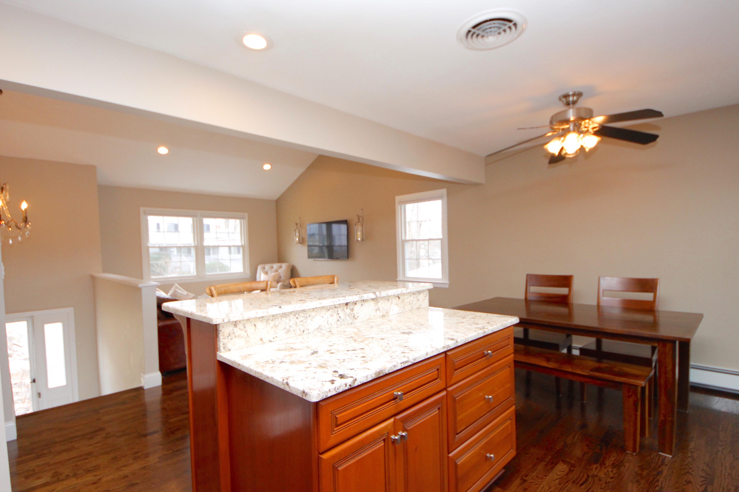 27 Thomes Street Rowayton, CT 06853 - Photo 5 of 19 a view of a kitchen with kitchen island dining table and wooden floor