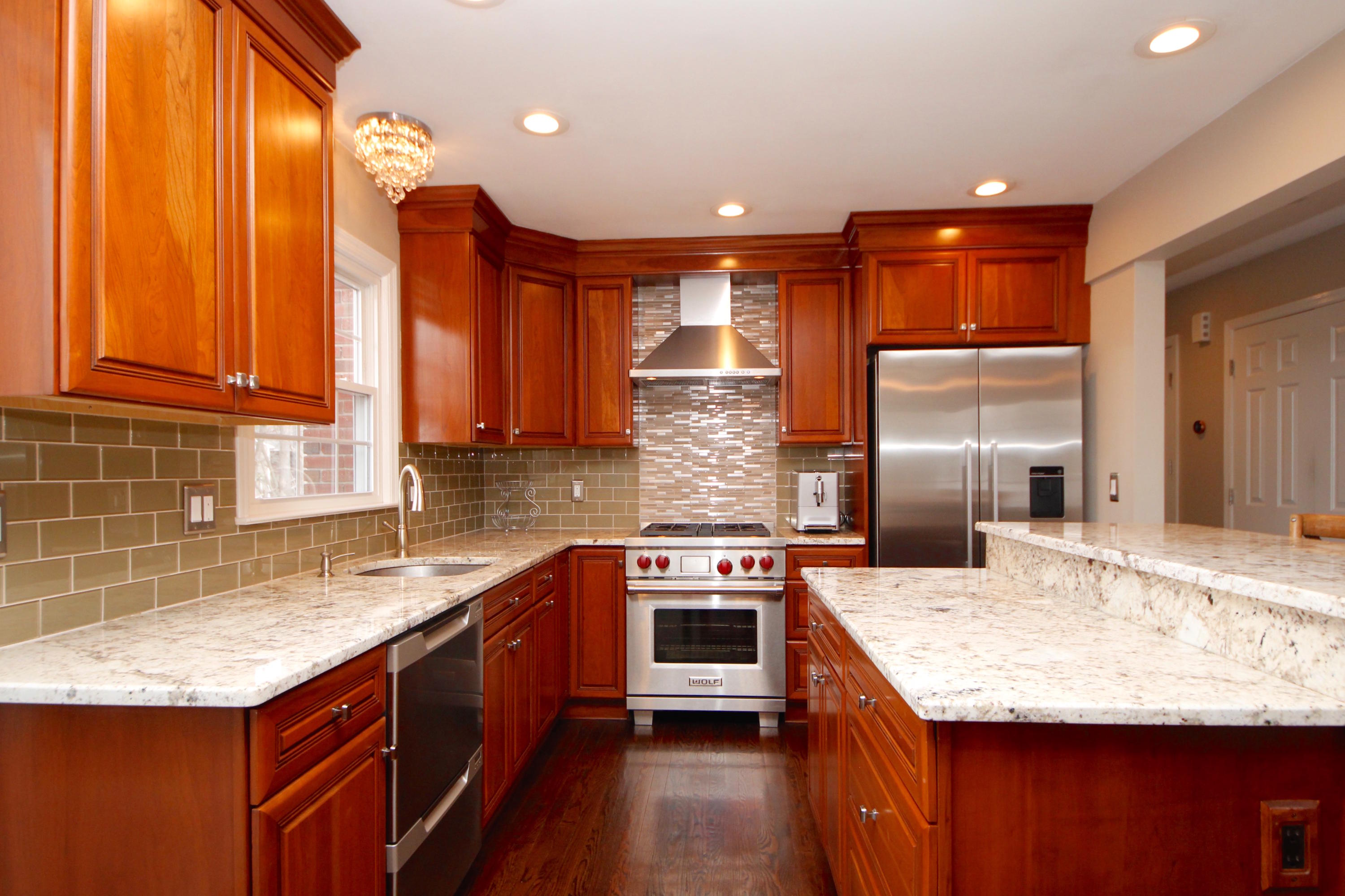 27 Thomes Street Rowayton, CT 06853 - Photo 6 of 19 a kitchen with stainless steel appliances granite countertop a sink a stove and a refrigerator