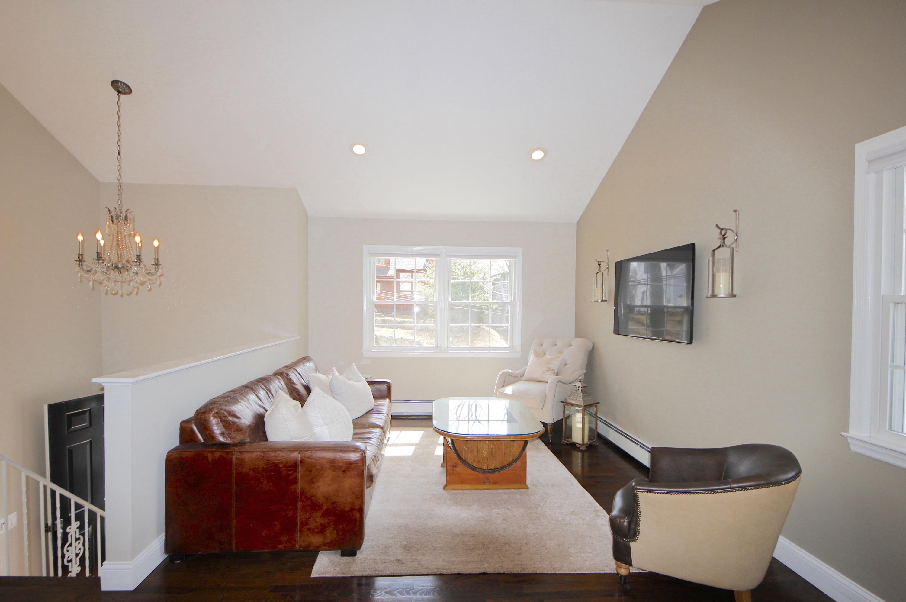 27 Thomes Street Rowayton, CT 06853 - Photo 8 of 19 a living room with furniture and a chandelier