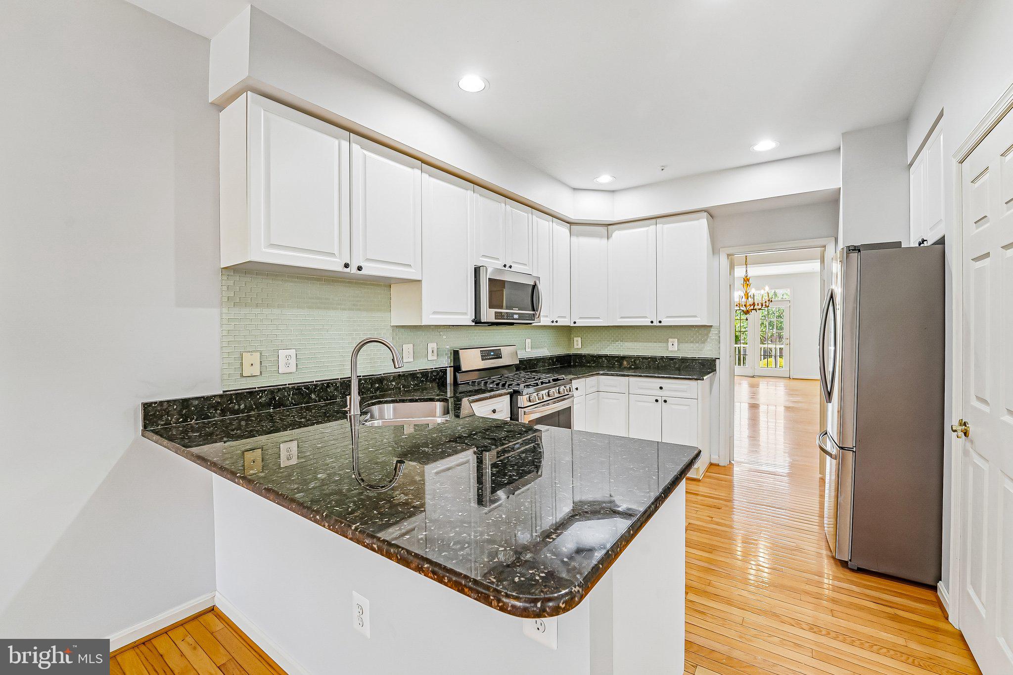 2422 Rippling Brook Road Frederick, MD 21701 - Photo 6 of 35 a kitchen with stainless steel appliances granite countertop a sink a stove and a refrigerator