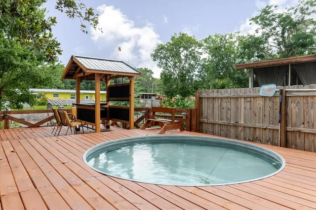 a kitchen with stainless steel appliances granite countertop a refrigerator a stove and a window