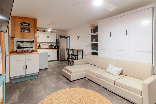 a kitchen with stainless steel appliances kitchen island granite countertop a refrigerator and a stove