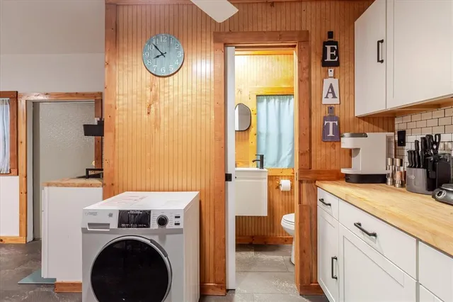 a kitchen with stainless steel appliances granite countertop a refrigerator and a stove